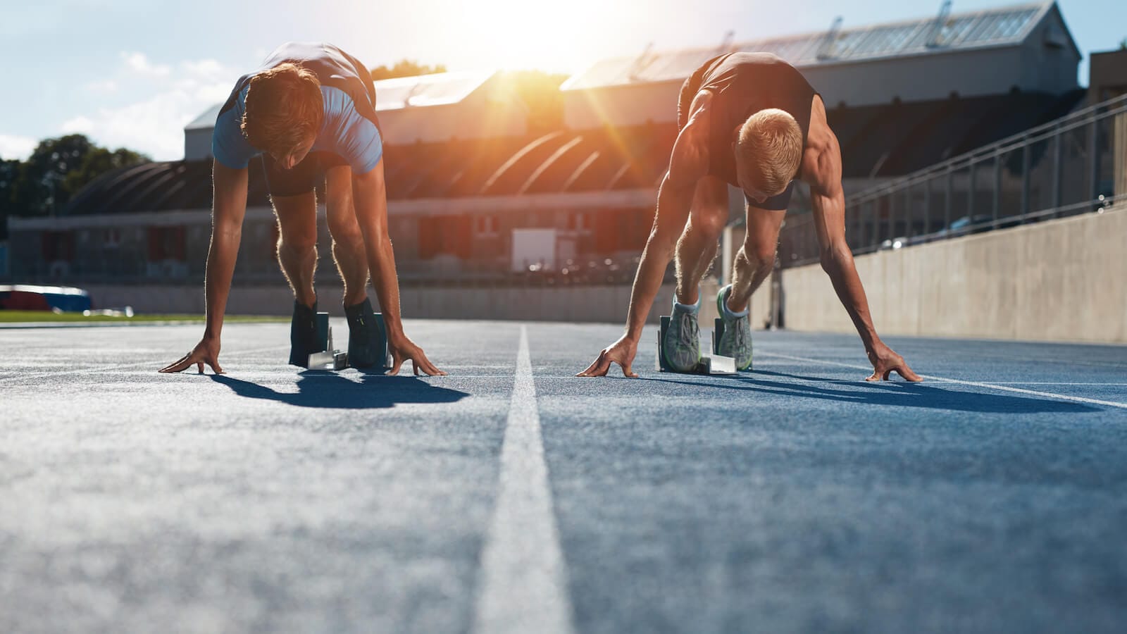 Two strong runners at starting line