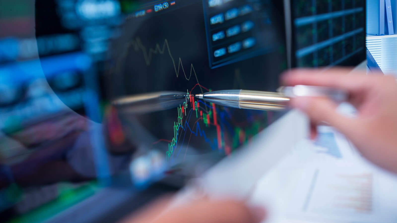 Person analyzing a stock chart