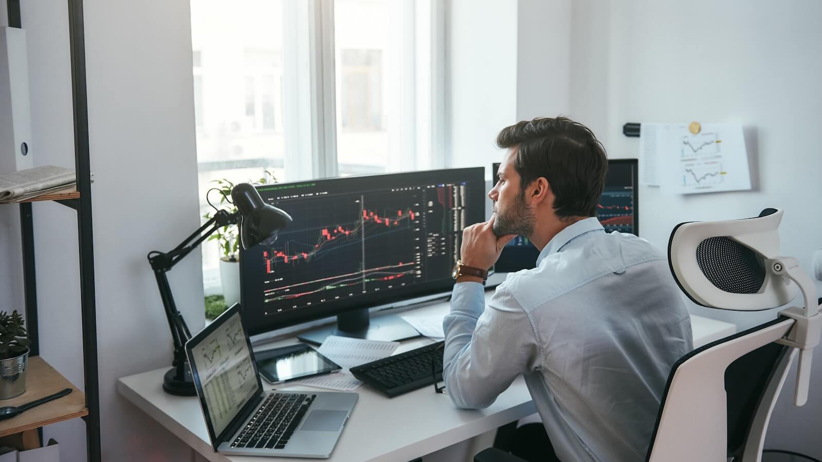 Investor watching charts on computer screen