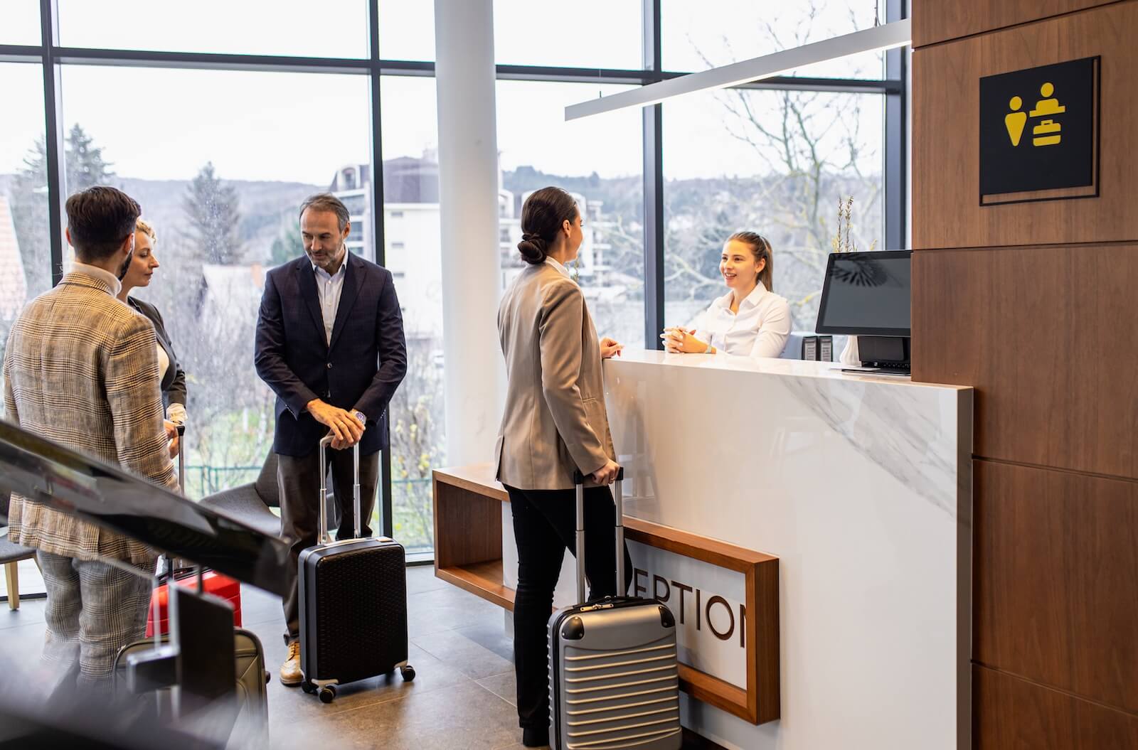 People checking in at a hotel